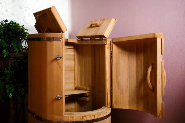 Cabinet for cosmetology procedures, rest and recovery with opened wooden phyto barrels for spa, wellness and skin care and human figure. Health and relaxation in beauty center