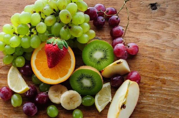 Juicy fruits on a wooden board — Stock Photo, Image