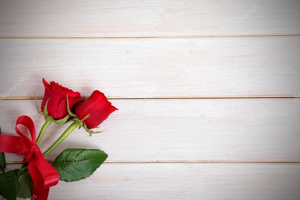 Valentine background of  red roses on  white wood. Space for cop