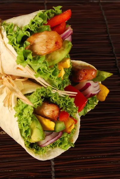 Several chicken wrap sandwiches on mat — Stock Photo, Image