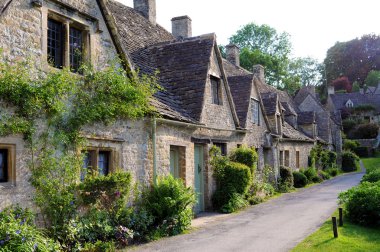 Traditional old houses in English countryside of Cotswolds clipart