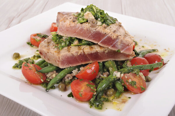 Seared tuna steak with bean and tomato salad