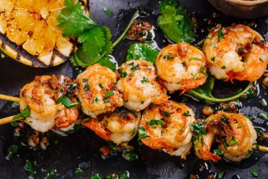 roasted shrimps on skewers with sauce and lemon clipart