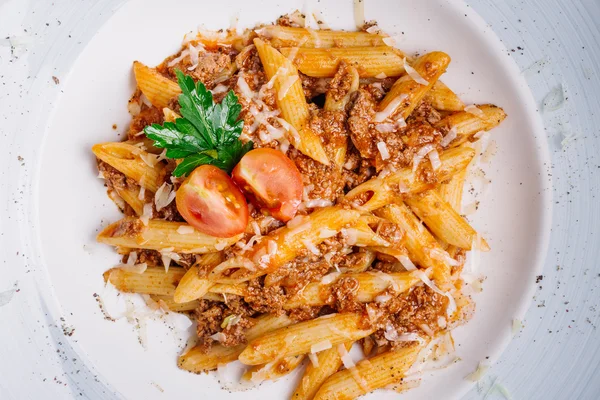 Pasta nautically with minced meat on wood table — Stock Photo, Image