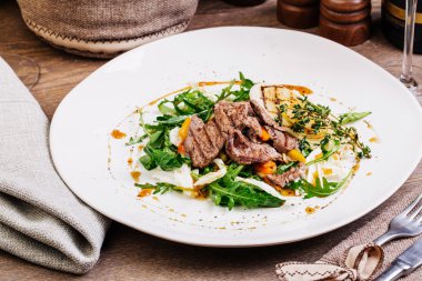 Beyaz tabak salataya sığır eti