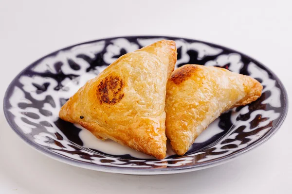 Delicious samosa pies with meat on plate. Menu, restaurant, recipe concept. — Stock Photo, Image