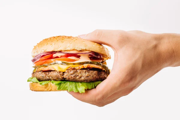 Man holding a burger on white background — Stock Photo, Image