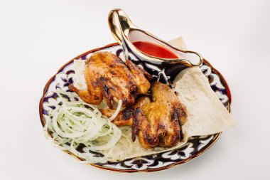 Bıldırcın sosu ile çanak üzerinde ve soğan üzerinde beyaz bir backgro füme