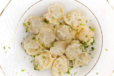 Portion of ravioli with parsley on a white plate