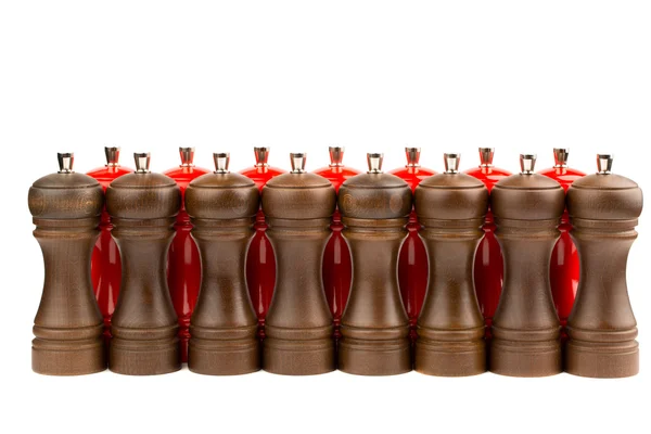 Red salt and brown  pepper shakers isolated on white — Stock Photo, Image