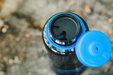 bottle on wood  with summer scene background