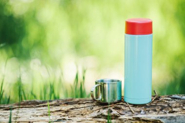 bottle on wood  with summer scene background