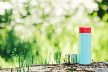 bottle on wood  with summer scene background