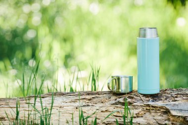 bottle on wood  with summer scene background