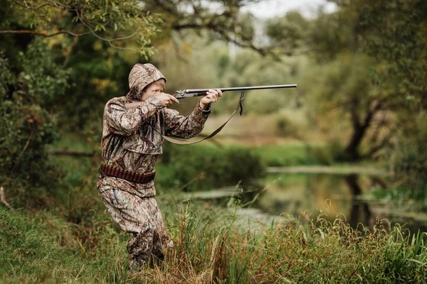 Cacciatore in abiti mimetici pronto a cacciare con fucile da caccia — Foto Stock