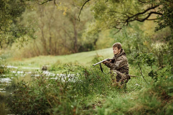 Cacciatore in abiti mimetici pronto a cacciare con fucile da caccia — Foto Stock