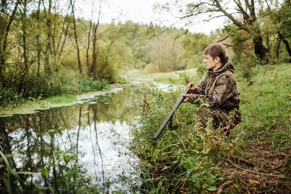 Chasseur en vêtements de camouflage prêt à chasser avec fusil de chasse — Photo