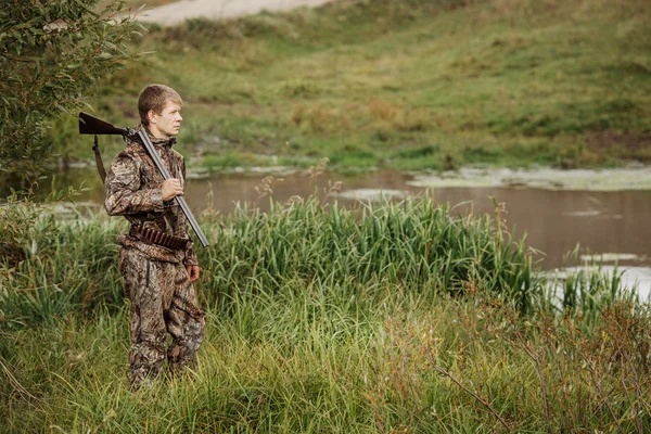 Jager in camouflage kleding klaar om te jagen met jachtgeweer — Stockfoto