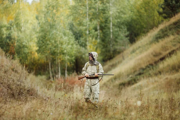 Hunter em roupas de camuflagem pronto para caçar com espingarda de caça — Fotografia de Stock