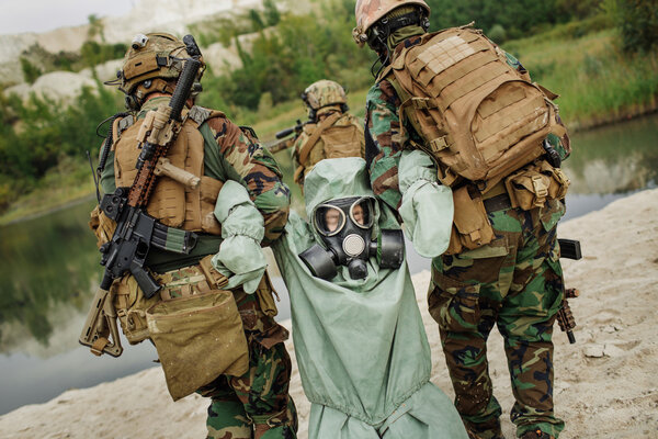 Army rangers captured a scientist with protective mask and prote
