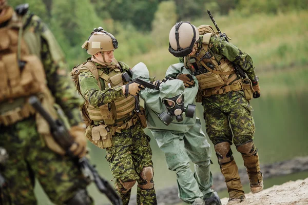 Army rangers captured a scientist with protective mask and prote — Stock Photo, Image