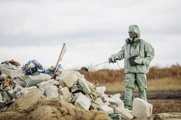 Scientist (radiation supervisor) in protective clothing and gas