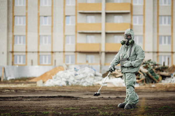 Scientist (radiation supervisor) in protective clothing and gas