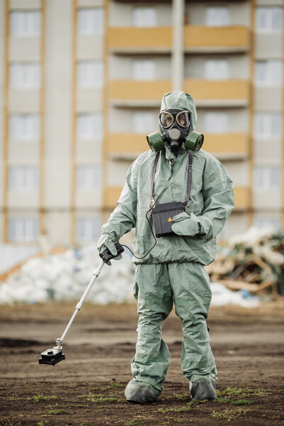 Scientist (radiation supervisor) in protective clothing and gas