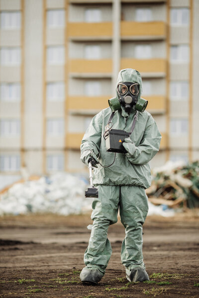 Scientist (radiation supervisor) in protective clothing and gas