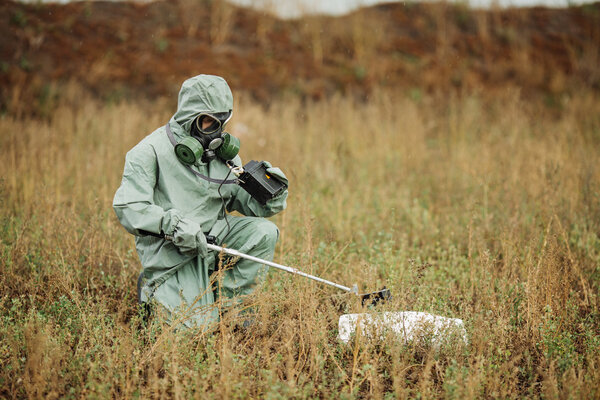 Scientist (radiation supervisor) in protective clothing and gas