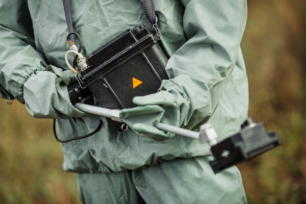 Scientist (radiation supervisor) in protective clothing and gas