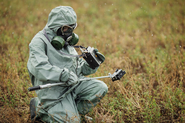 Scientist (radiation supervisor) in protective clothing and gas