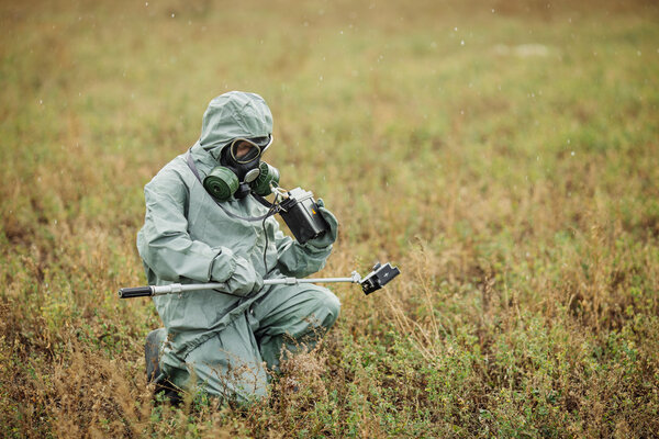 Scientist (radiation supervisor) in protective clothing and gas