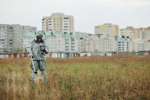 Scientist (radiation supervisor) in protective clothing and gas