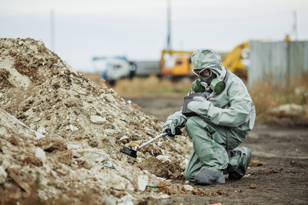 Scientist (radiation supervisor) in protective clothing and gas