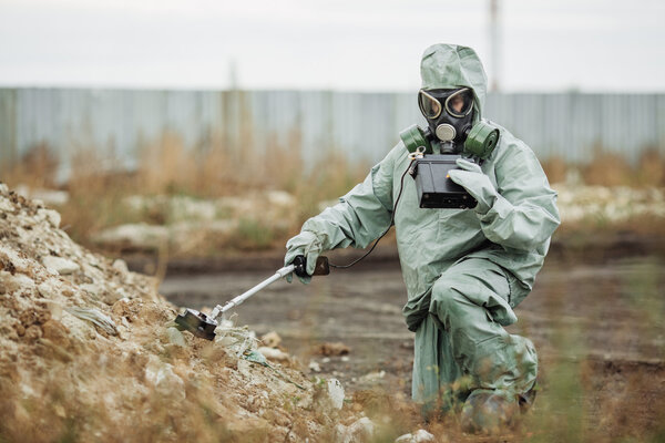 Scientist (radiation supervisor) in protective clothing and gas