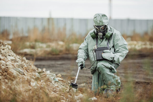 Scientist (radiation supervisor) in protective clothing and gas