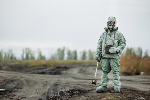 Scientist (radiation supervisor) in protective clothing and gas