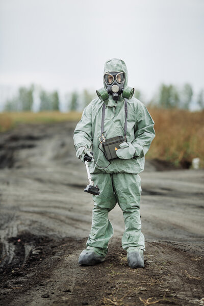 Scientist (radiation supervisor) in protective clothing and gas