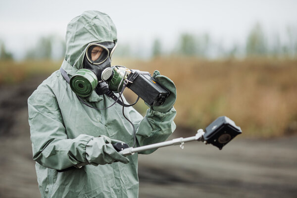 Scientist (radiation supervisor) in protective clothing and gas