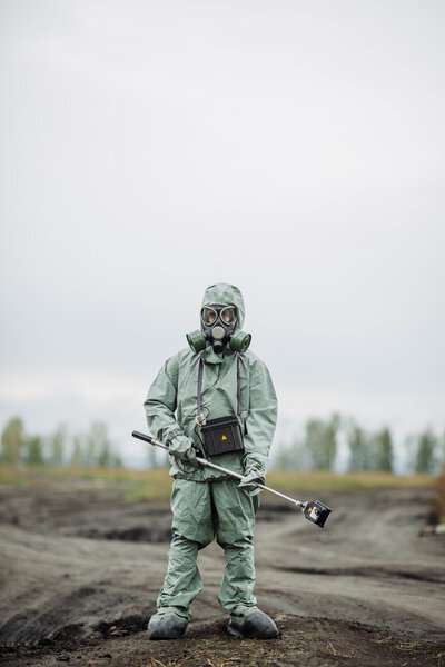 Scientist (radiation supervisor) in protective clothing and gas