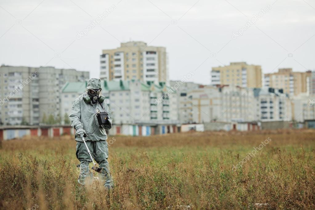 Scientist (radiation supervisor) in protective clothing and gas