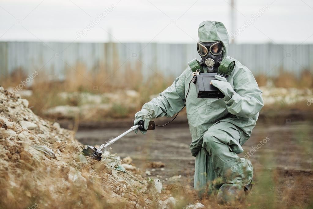 Scientist (radiation supervisor) in protective clothing and gas