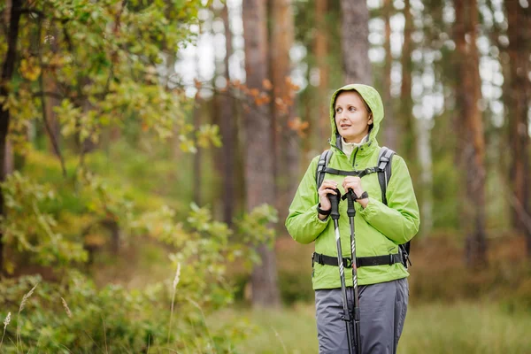 Mujer con equipo de senderismo caminando en el bosque — Foto de Stock