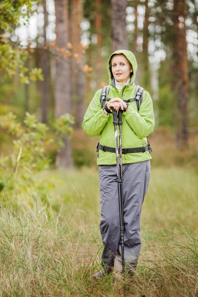 Mujer con equipo de senderismo caminando en el bosque — Foto de Stock