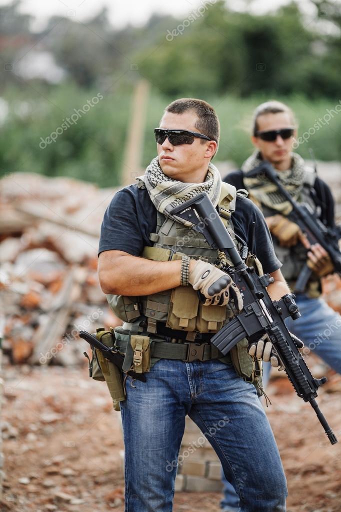 Private Military Contractor on patrol in destroyed city — Stock Photo © kaninstudio #88675492