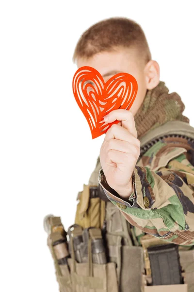 Young soldier holding red heart in his hands — Stock Photo, Image