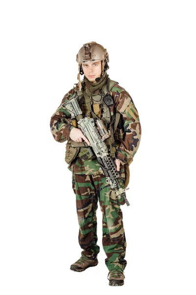 Young ranger standing with a machine gun at white background — Stock Photo, Image