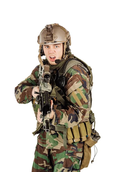 Young ranger standing with a machine gun at white background — Stock Photo, Image