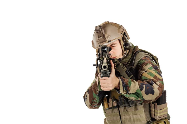 Young ranger standing with a machine gun at white background — Stock Photo, Image